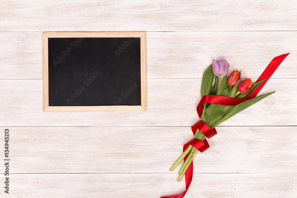 Lilac and red tulips and banner space for text in the white wooden table. Banner template layout mockup for Woman Day, Valentines Day and Teacher's Day. 