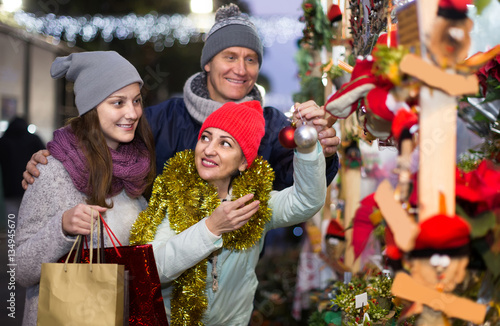 Portrait of family couple with teen girl at Christmas fair