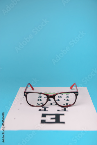 glasses lying on snellen test chart