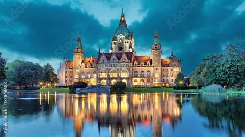 New City Hall of Hannover reflecting in water in the evening  (static image with animated sky)
