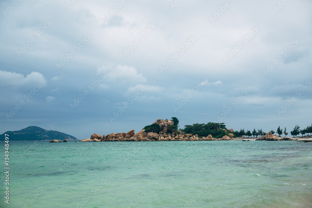 Beautiful landscape with view of ocean, perfect beach, big stones, trees, azure water. Background image. Concept  travel