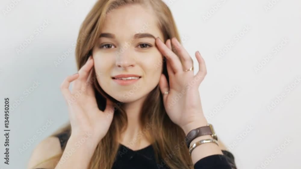 Beautiful woman posing with hands at face - white background Beautiful woman posing with hands at face - white background