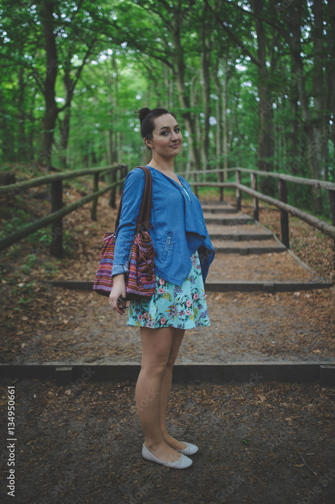 Fototapeta premium Young girl on a walk in the forest