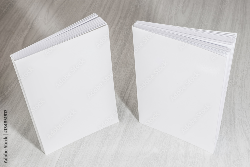 Fototapeta premium Real 3D paperback white books on a wood background