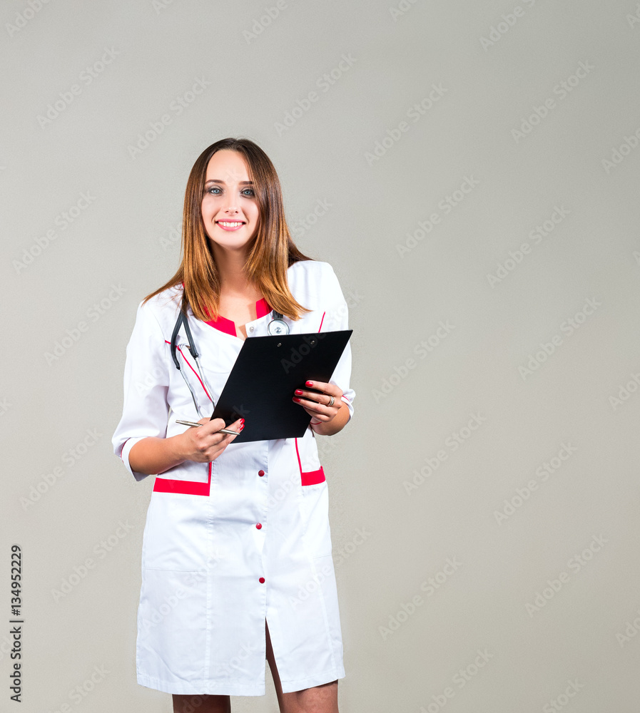 woman doctor, nurse smiles holding a clipboard, with space for text woman doctor, nurse smiles holding a clipboard, with space for text