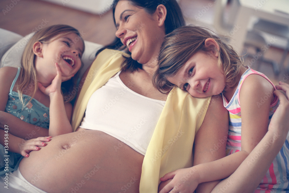 Pregnant woman and her little daughters. Pregnant woman and her little daughters.