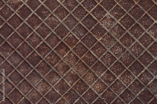 Canal cover surface texture. Rusty iron square pattern. Rusty metal square texture. Robust old iron rusted canal cover wallpaper. Ruststained canal grid form cover backdrop. Ironworks theme background