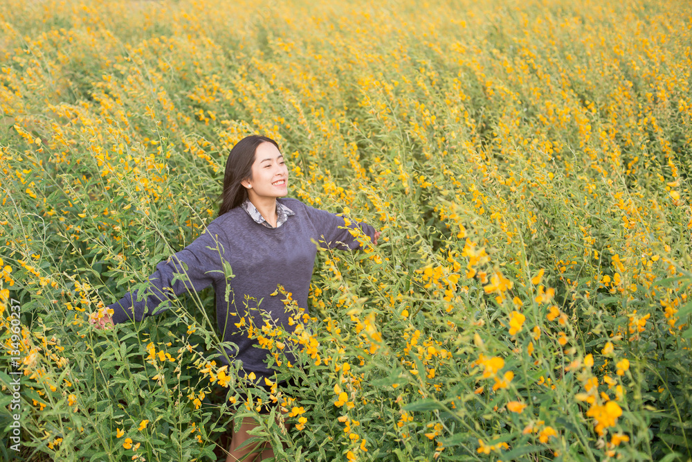 happy young woman enjoying summer in yellow field at sunset happy young woman enjoying summer in yellow field at sunset