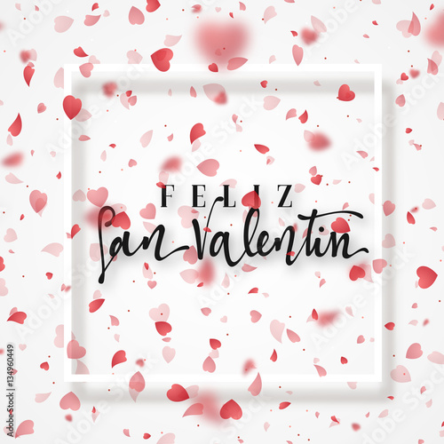 Happy Valentines Day. lettering Spanish Inscription handmade. Greeting card. Bright red hearts flying in the form of petals on a white background. Pink heart in frame.
