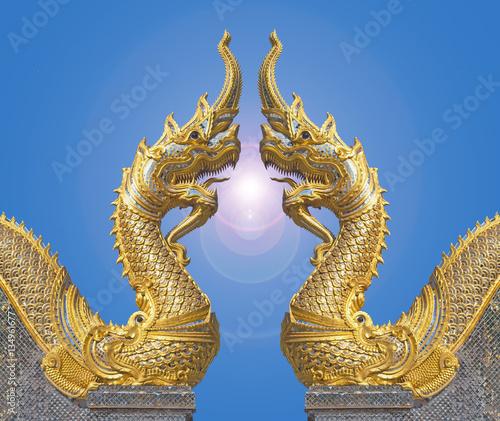 Naga facing each other with flare in blue sky at the temple is a
