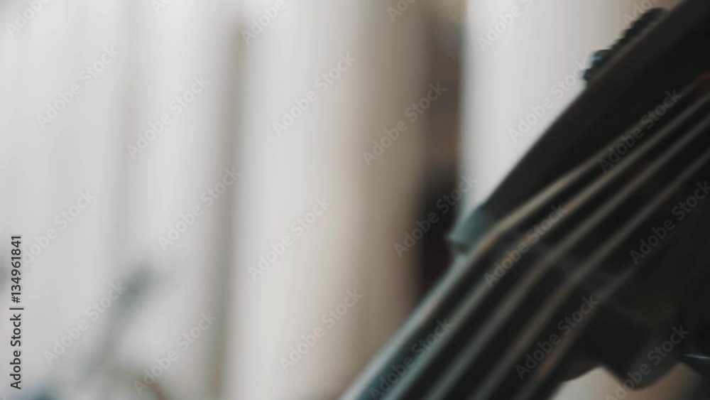Close up dolly shot of a cello scroll and tuning pegs Close up dolly shot of a cello scroll and tuning pegs