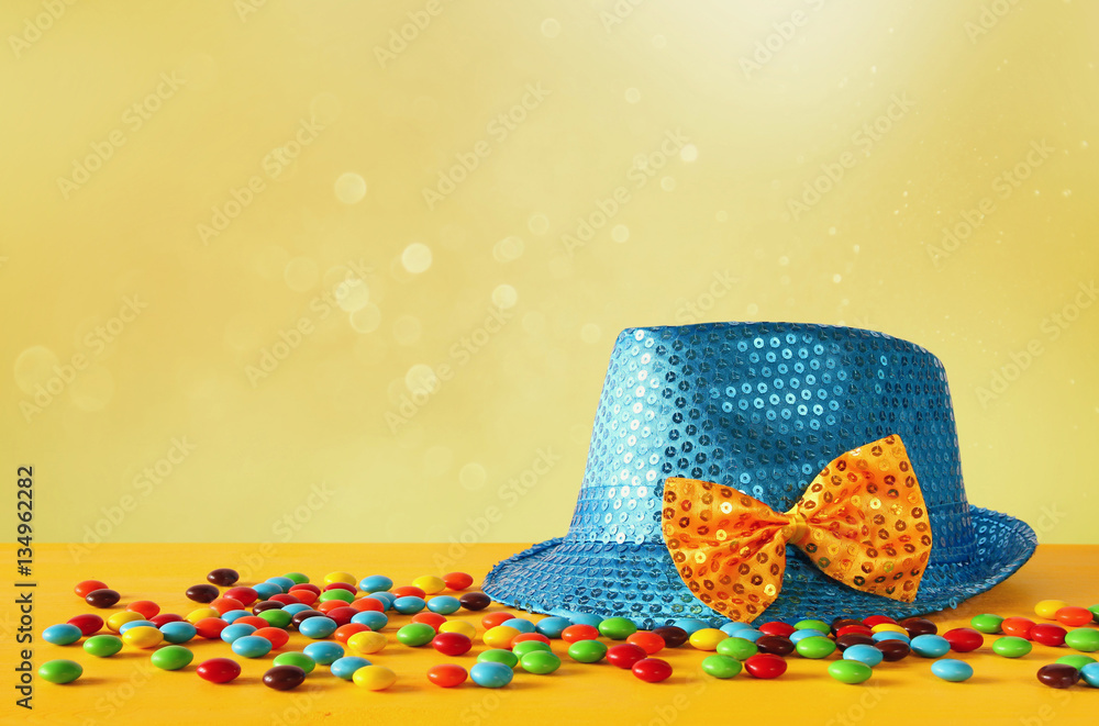 Blue shiny party Hat next to colorful candies