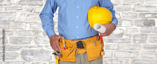 Construction worker with helmet and tool belt.