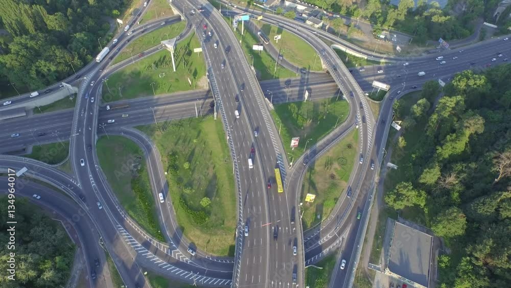 Road junction with heavy traffic in Kyiv, Ukraine. View from above. Aerial view of a truck and other traffic driving along a road. Paton Bridge Road junction with heavy traffic in Kyiv, Ukraine. View from above. Aerial view of a truck and other traffic driving along a road. Paton Bridge