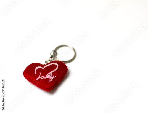 Key chain in form of red heart on white background