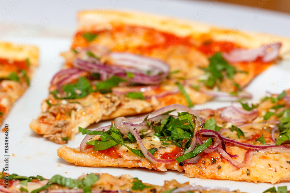 Pizza with tuna, cheese, tomatoes red onion is on the table. Pizza with tuna, cheese, tomatoes red onion is on the table.