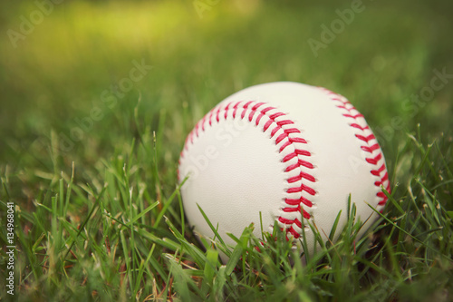 Photography a baseball in the grass.
