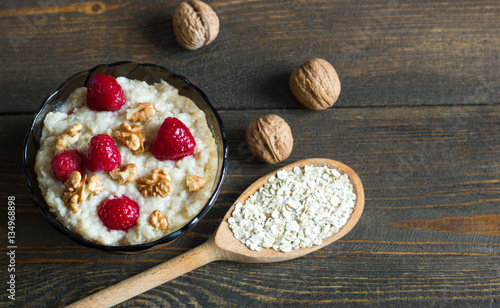 Healthy breakfast, oatmeal with raspberries and walnuts