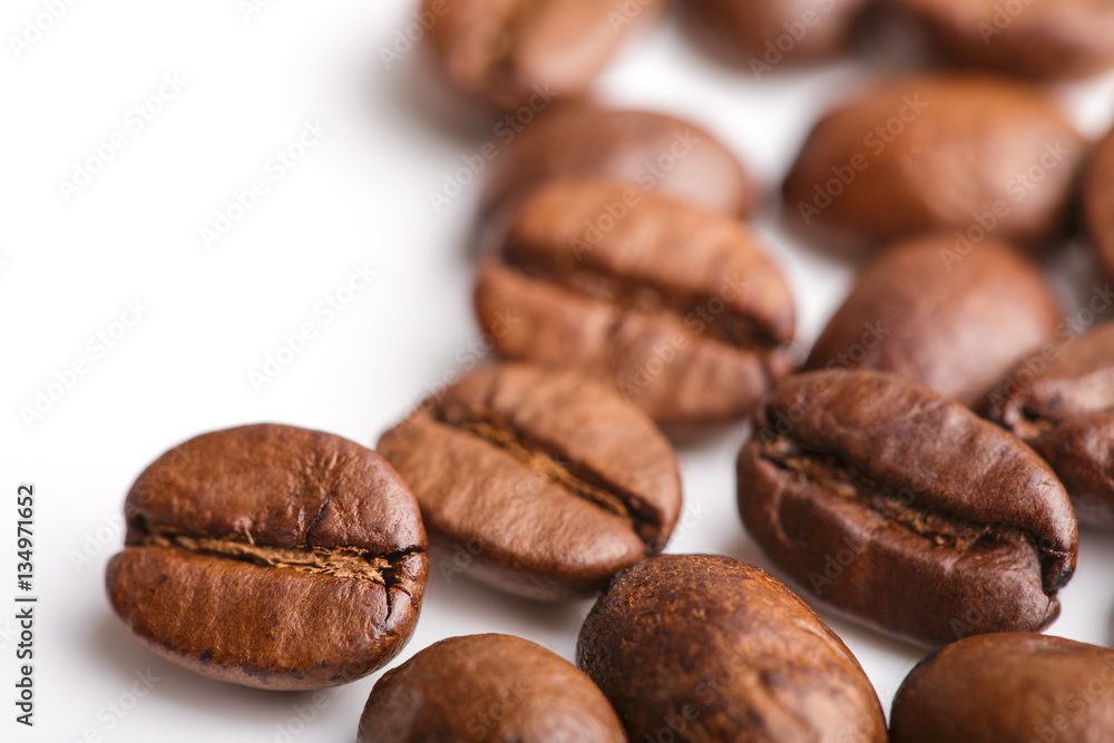 roasted coffee beans isolated in white background. Roasted coffee beans background close up. Coffee beans pile from top on white background with copy space for text. Good morning. roasted coffee beans isolated in white background. Roasted coffee beans background close up. Coffee beans pile from top on white background with copy space for text. Good morning.