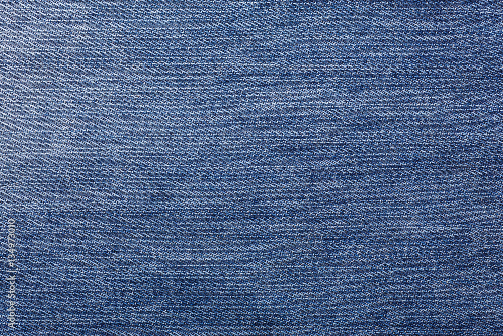 Naklejka premium Denim jeans tekstura tło z rozdarty. Faktura kolorowej tkaniny bawełnianej. Szyte tekstury dżinsy tło. Modny guzik do dżinsów. Kieszeń i nit na dżinsach. Struktura włókna i tkaniny.