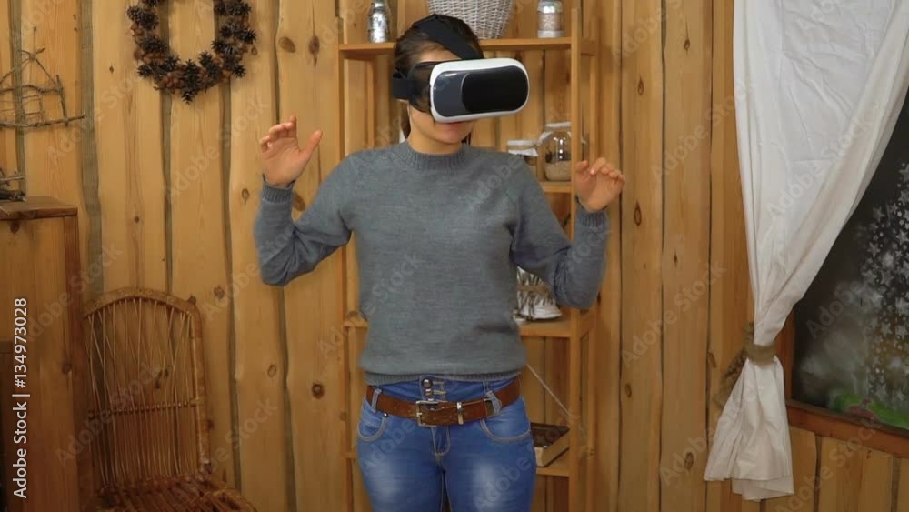 Young brunette woman using vr glasses at home Young brunette woman using vr glasses at home
