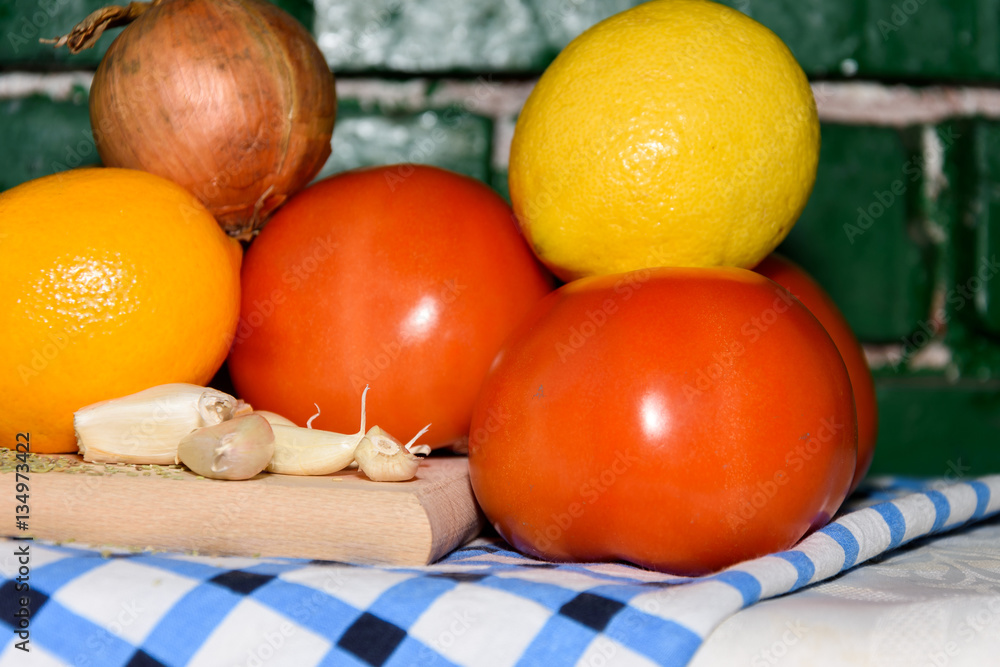 Vegetables tomato onion garlic lemon seasoning cutting board Vegetables tomato onion garlic lemon seasoning cutting board
