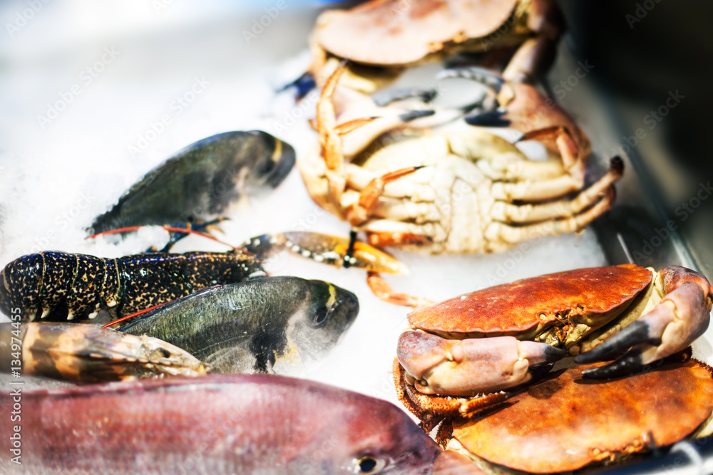 Seafood assortment on ice at the fish market stall close up. Seafood assortment on ice at the fish market stall close up.