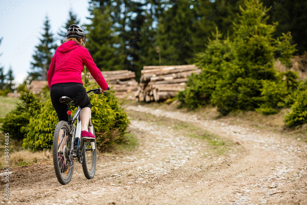 Fototapeta premium Middle-aged woman riding bicycle 