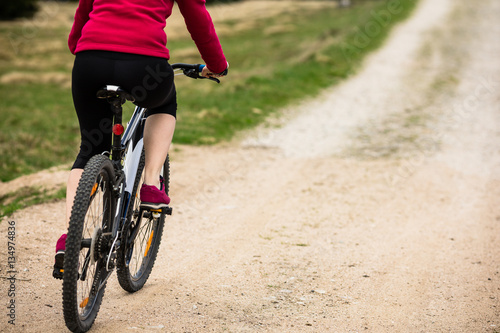 Middle-aged woman riding bicycle 