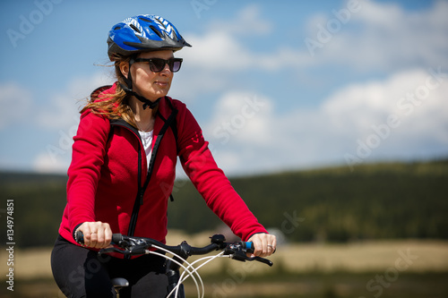 Middle-aged woman riding bicycle  © Jacek Chabraszewski