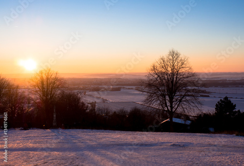 Sunset over the city of Olomouc, view from Svaty Kopecek (Holly Hill) in winter, Czech Republic. © sleepyhobbit