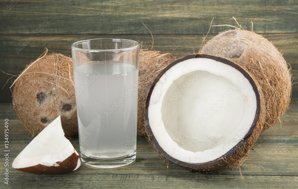 Coconut water on the wooden table (Cocos nucifera) Coconut water on the wooden table (Cocos nucifera)