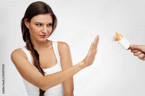 Beautiful Healthy Woman Quitting Smoking  Refusing Cigarettes.
