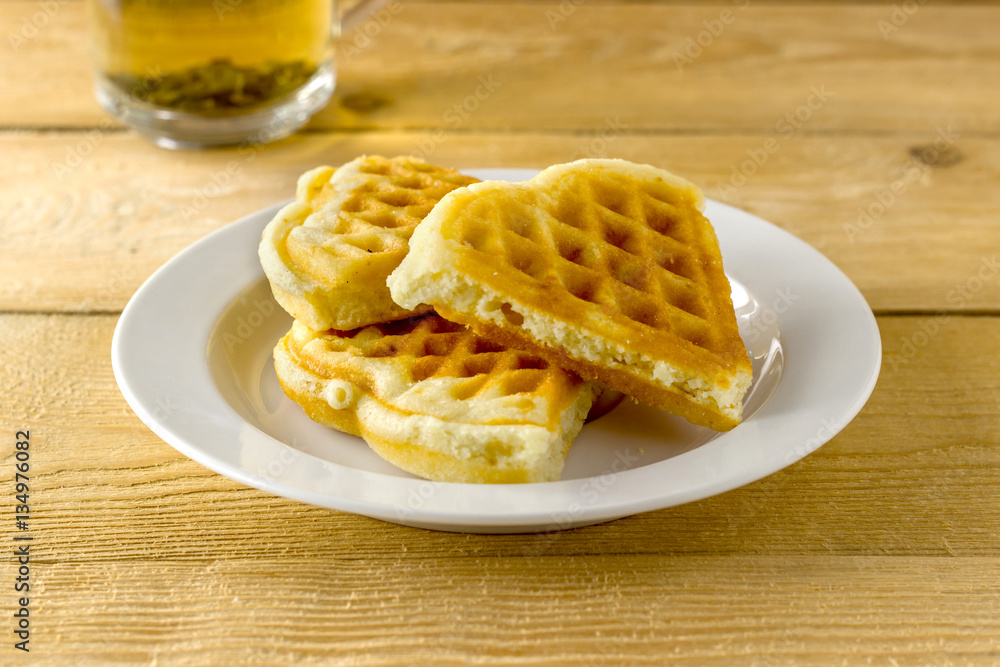 Green tea in a transparent mug with waffle Green tea in a transparent mug with waffle