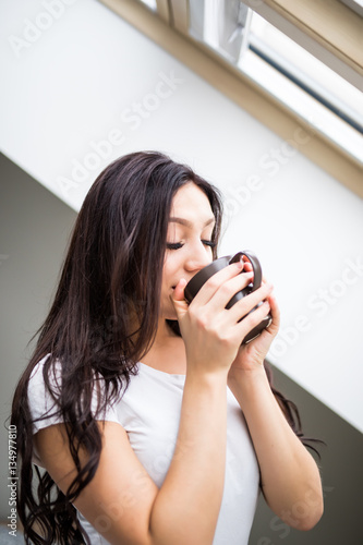 Portrait of beauty woman drink cup of tea or coffee in the morning bedroom