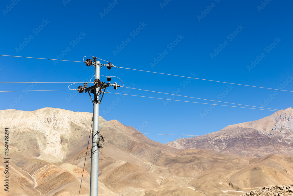 broken insulator on a transmission tower in the mountains broken insulator on a transmission tower in the mountains
