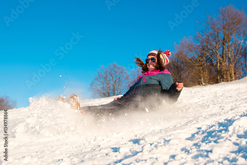 Girl falling down on the snow