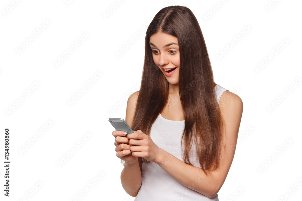 Happy excited woman looking at mobile phone while text messaging, isolated on white background Happy excited woman looking at mobile phone while text messaging, isolated on white background