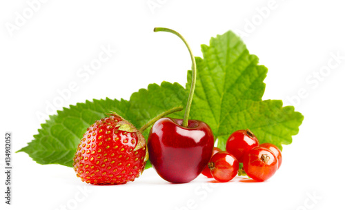 Strawberry, red currant and cherry with green leaves isolated on white background