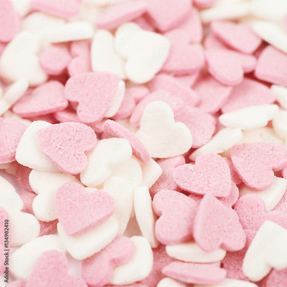 Surface coated with heart shaped sprinkles Surface coated with heart shaped sprinkles