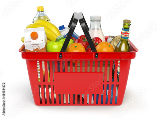 Shopping market basket with variety of grocery products isolated on whi photo
