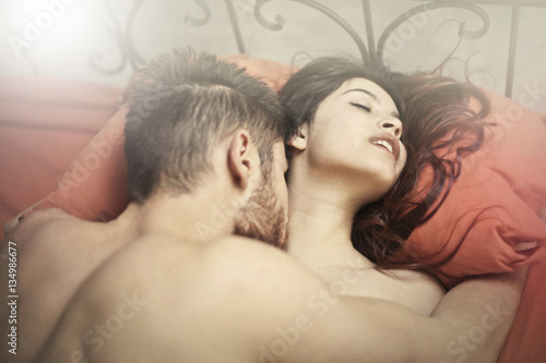 Couple making love in red bed 