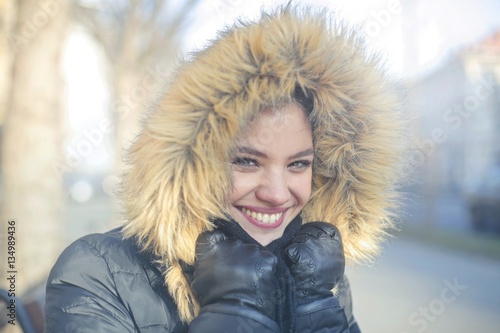 Smiley girl in furry hood 