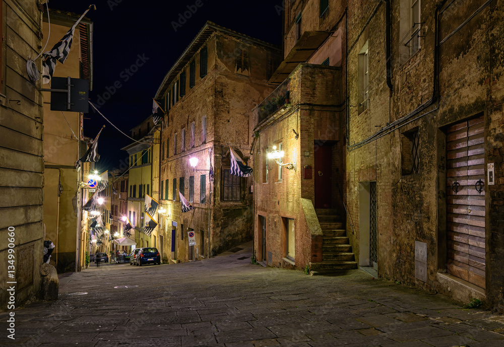 Medieval narrow cozy street in Siena, Tuscany, Italy