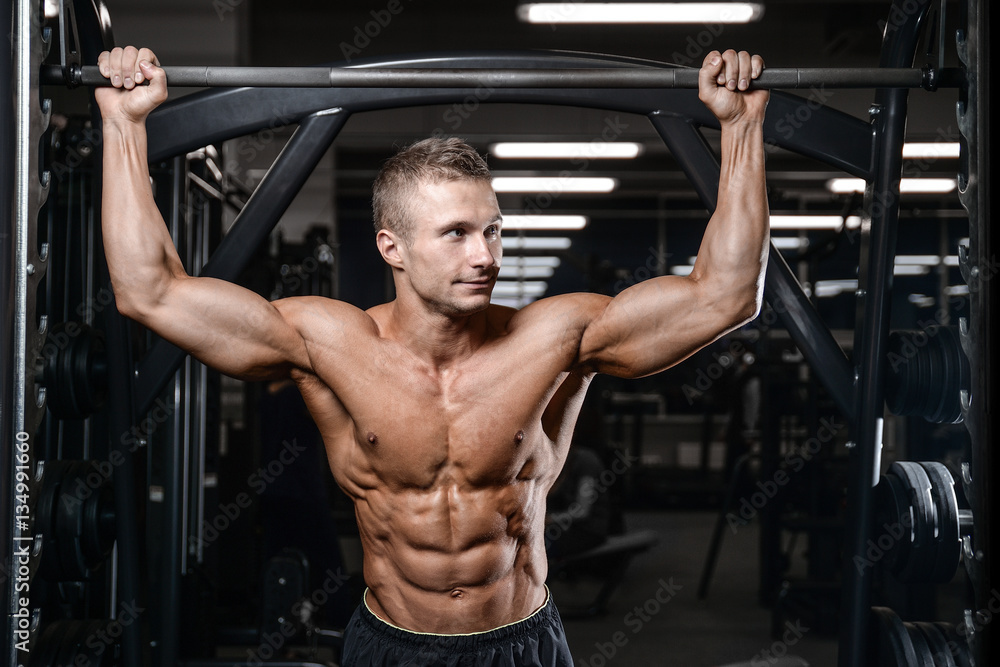 Handsome fitness model train in the gym gain muscle Handsome fitness model train in the gym gain muscle