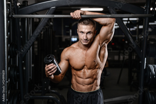 Handsome fitness model train in the gym gain muscle