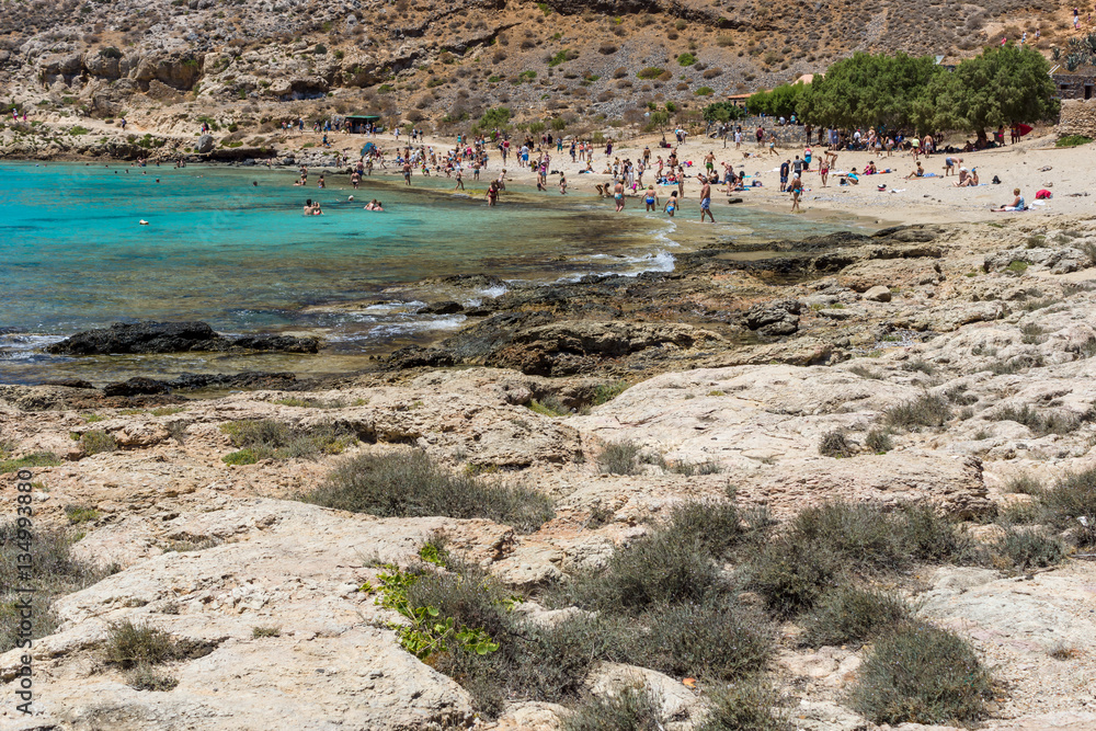 Tourists on the beach of island Imeri Gramvousa. Mediterranean Sea. Crete. Greece. Tourists on the beach of island Imeri Gramvousa. Mediterranean Sea. Crete. Greece.