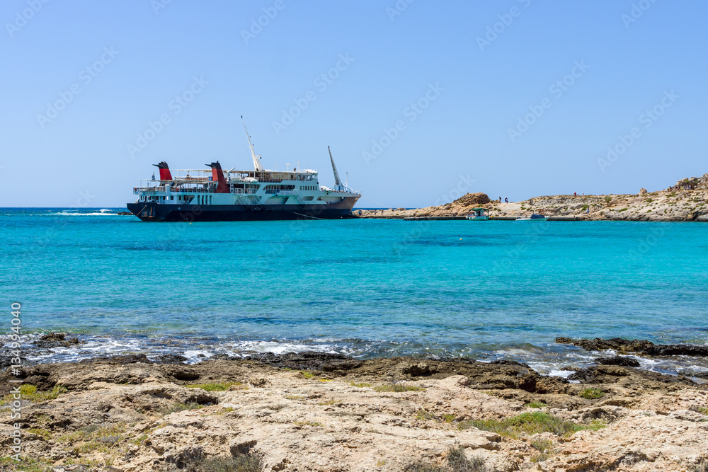 View on the bay of island Imeri Gramvousa, Mediterranean Sea. In the background a cruise ship. Crete. Greece.