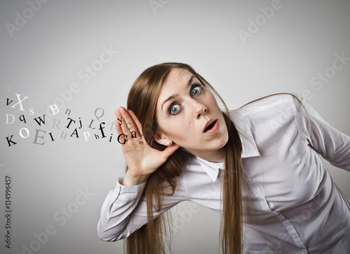 Curious woman in white and letters.