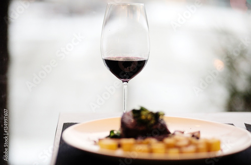 beef Steak with roasted potato and glass of red wine